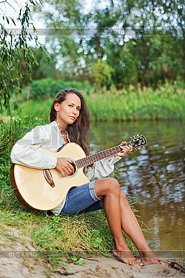 Beautiful young woman with guitar on the river coast | High resolution stock photo |ID 3017243